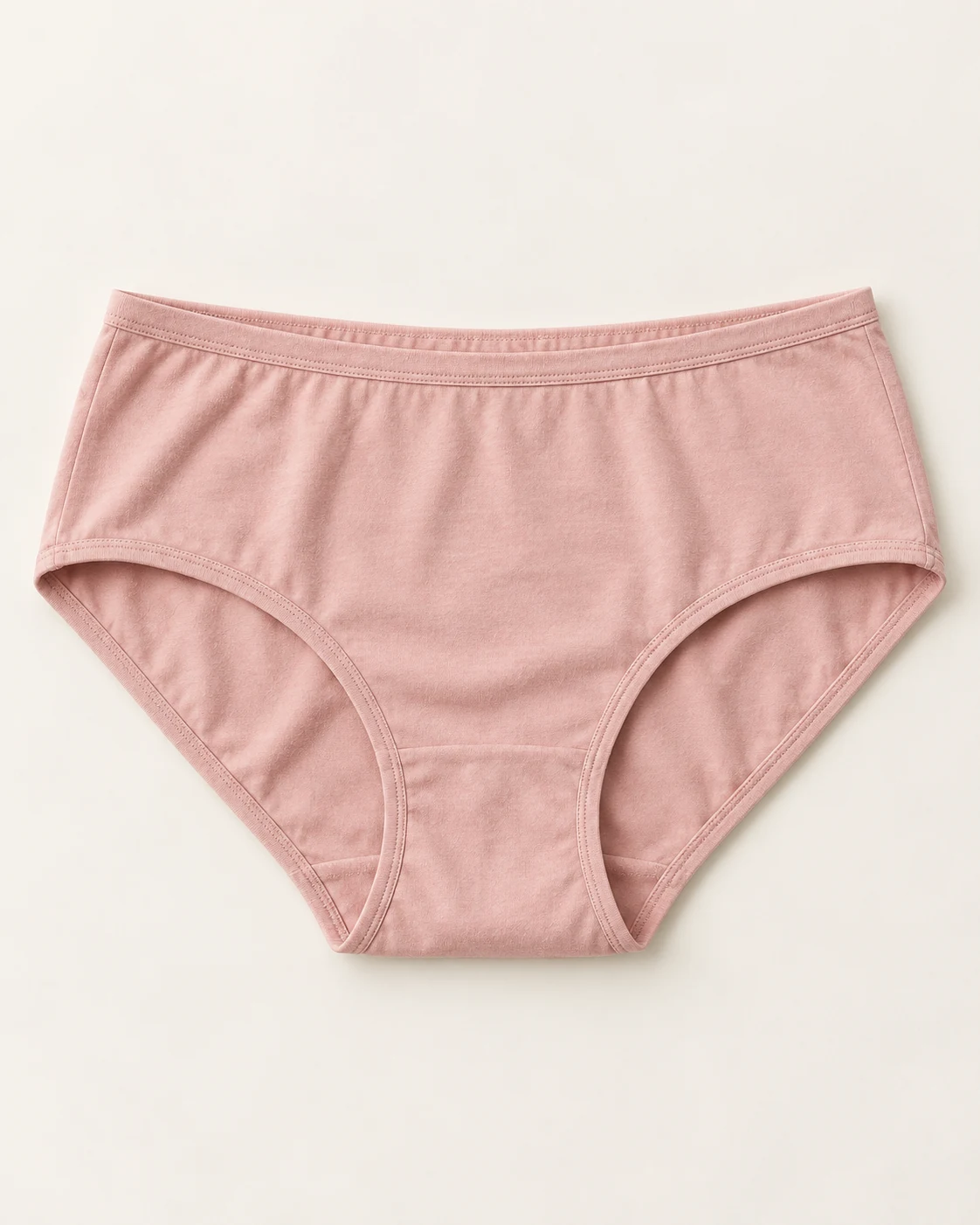 Blush full briefs with a lower waist, broad sides, and curved leg openings.